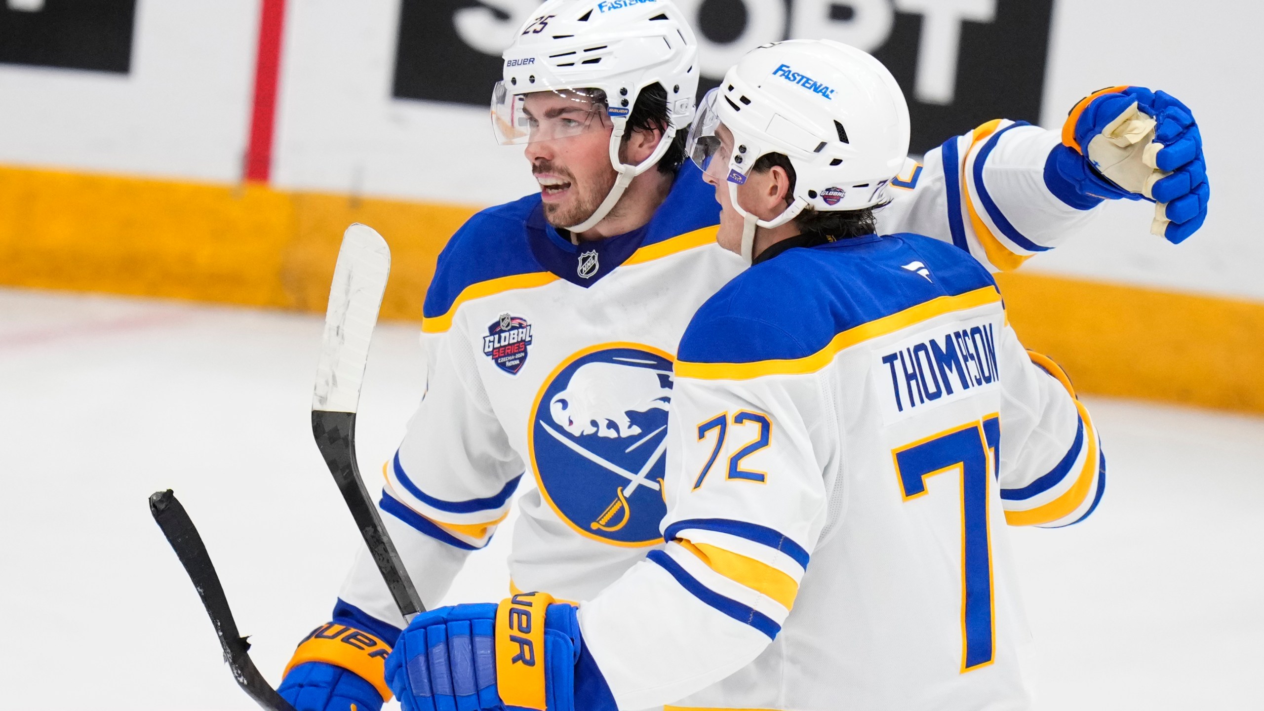 Buffalo Sabres' Owen Power, left, celebrates with Buffalo Sabres' Tage Thompson after scoring his side's first goal during the NHL hockey game between Buffalo Sabres and New Jersey Devils, in Prague, Czech Republic, Friday, Oct. 4, 2024. (AP Photo/Petr David Josek)