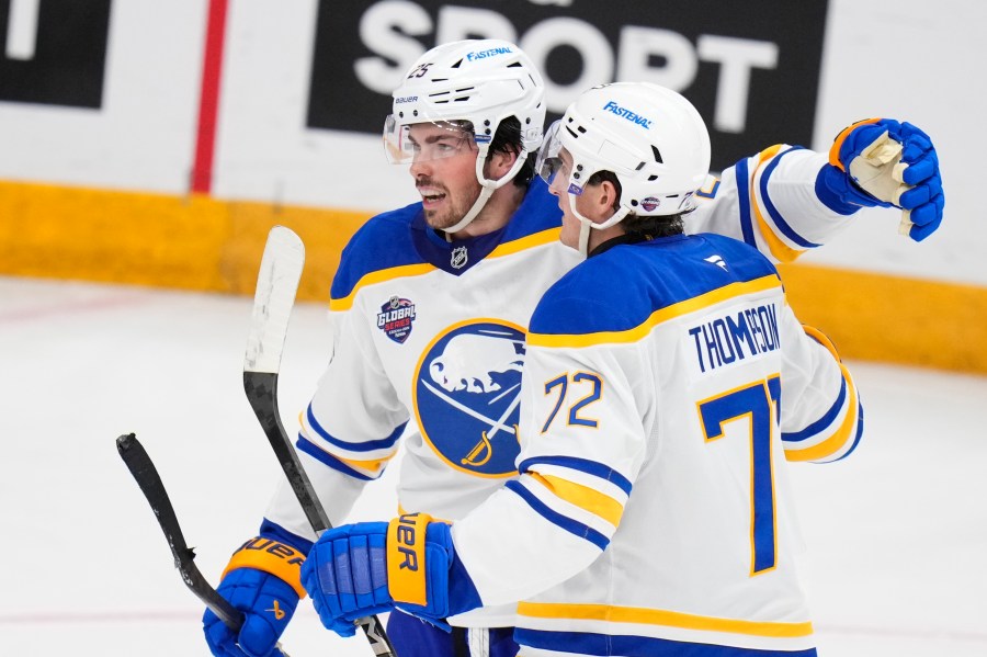 Buffalo Sabres' Owen Power, left, celebrates with Buffalo Sabres' Tage Thompson after scoring his side's first goal during the NHL hockey game between Buffalo Sabres and New Jersey Devils, in Prague, Czech Republic, Friday, Oct. 4, 2024. (AP Photo/Petr David Josek)