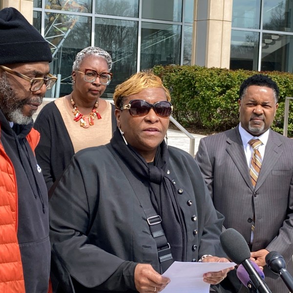 FILE - Timothy McCree Johnson's parents Melissa Johnson, center, and Timothy Walker, left, address reporters along with attorney Carl Crews, right, outside Fairfax County Police headquarters, March 22, 2023, in Fairfax, Va. (AP Photo/Matthew Barakat, File)