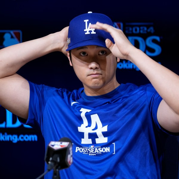 Los Angeles Dodgers' Shohei Ohtani speaks to reporters in a press conference in preparation for Game 1 of a baseball NL Division Series against the San Diego Padres in Los Angeles, Friday, Oct. 4, 2024. (AP Photo/Ashley Landis)