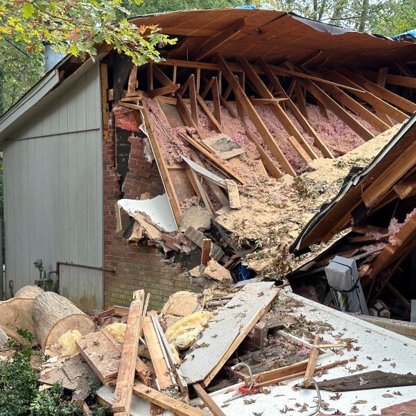 A damaged garage, caved in after a tree fell on it during the remnants of Hurricane Helene, is shown Friday, Oct. 4, 2024, in the Oak Forest neighborhood of Asheville, N.C. (AP Photo/Jeff Amy)