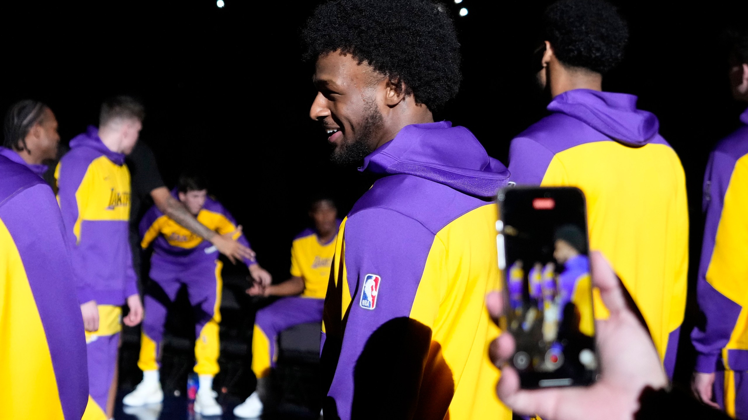 Los Angeles Lakers guard Bronny James stands on the court during introductions prior to a preseason NBA basketball game against the Minnesota Timberwolves, Friday, Oct. 4, 2024, in Palm Desert, Calif. (AP Photo/Mark J. Terrill)