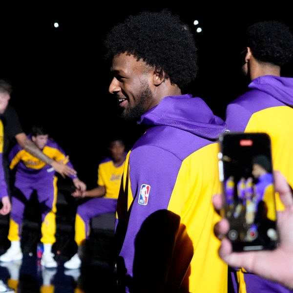 Los Angeles Lakers guard Bronny James stands on the court during introductions prior to a preseason NBA basketball game against the Minnesota Timberwolves, Friday, Oct. 4, 2024, in Palm Desert, Calif. (AP Photo/Mark J. Terrill)