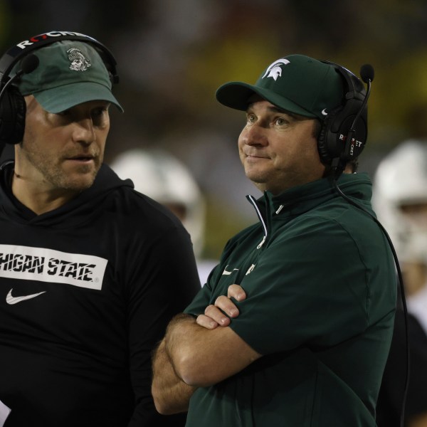 Michigan State head coach Jonathan Smith, right, reacts during the first half of an NCAA college football game against Oregon, Friday, Oct. 4, 2024, in Eugene, Ore. (AP Photo/Amanda Loman)