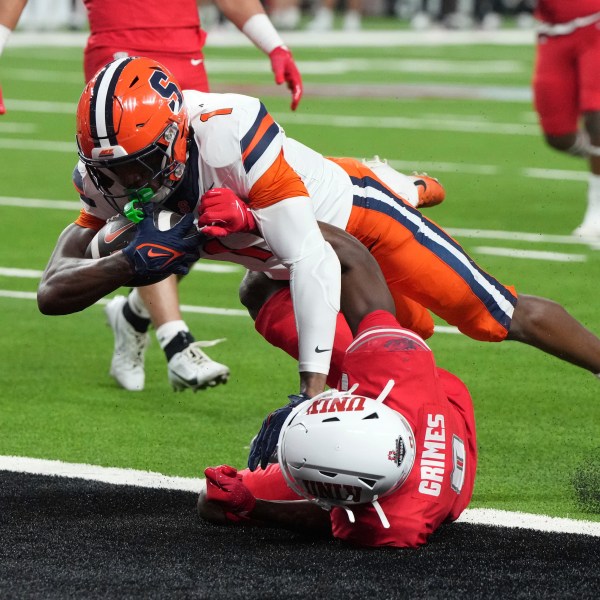 Syracuse running back LeQuint Allen (1) scores a touchdown over UNLV defensive back Tony Grimes, bottom, in the first half during an NCAA college football game, Friday, Oct. 4, 2024, in Las Vegas. (AP Photo/Rick Scuteri)