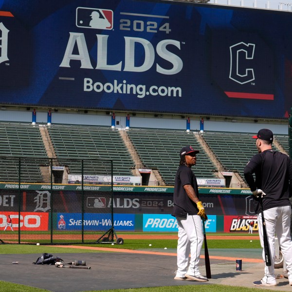 Cleveland Guardians' Jose Ramirez, left, and David Fry, right, talk near the batting cage during a baseball workout in Cleveland, Friday, Oct. 4, 2024, in preparation for the American League Division Series against the Detroit Tigers. (AP Photo/Sue Ogrocki)