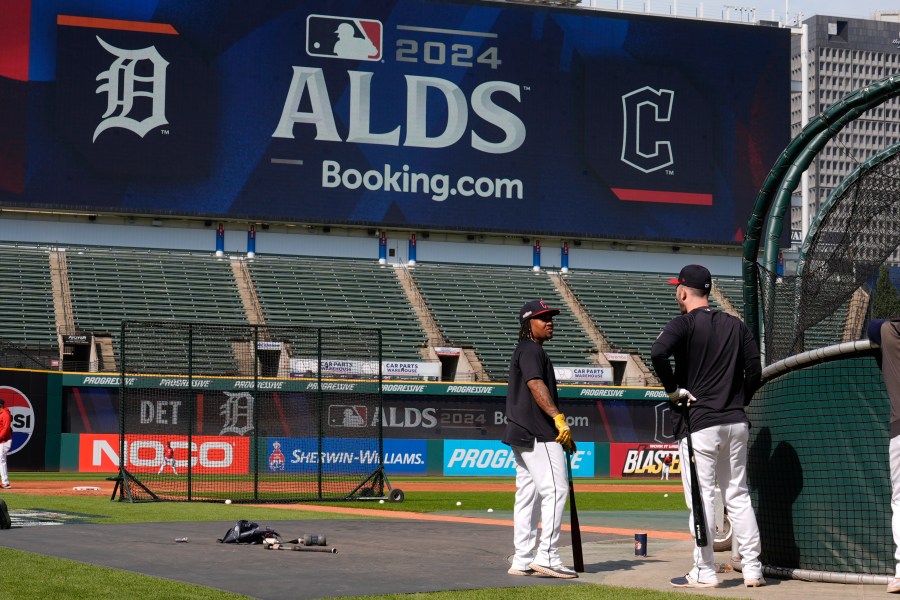 Cleveland Guardians' Jose Ramirez, left, and David Fry, right, talk near the batting cage during a baseball workout in Cleveland, Friday, Oct. 4, 2024, in preparation for the American League Division Series against the Detroit Tigers. (AP Photo/Sue Ogrocki)