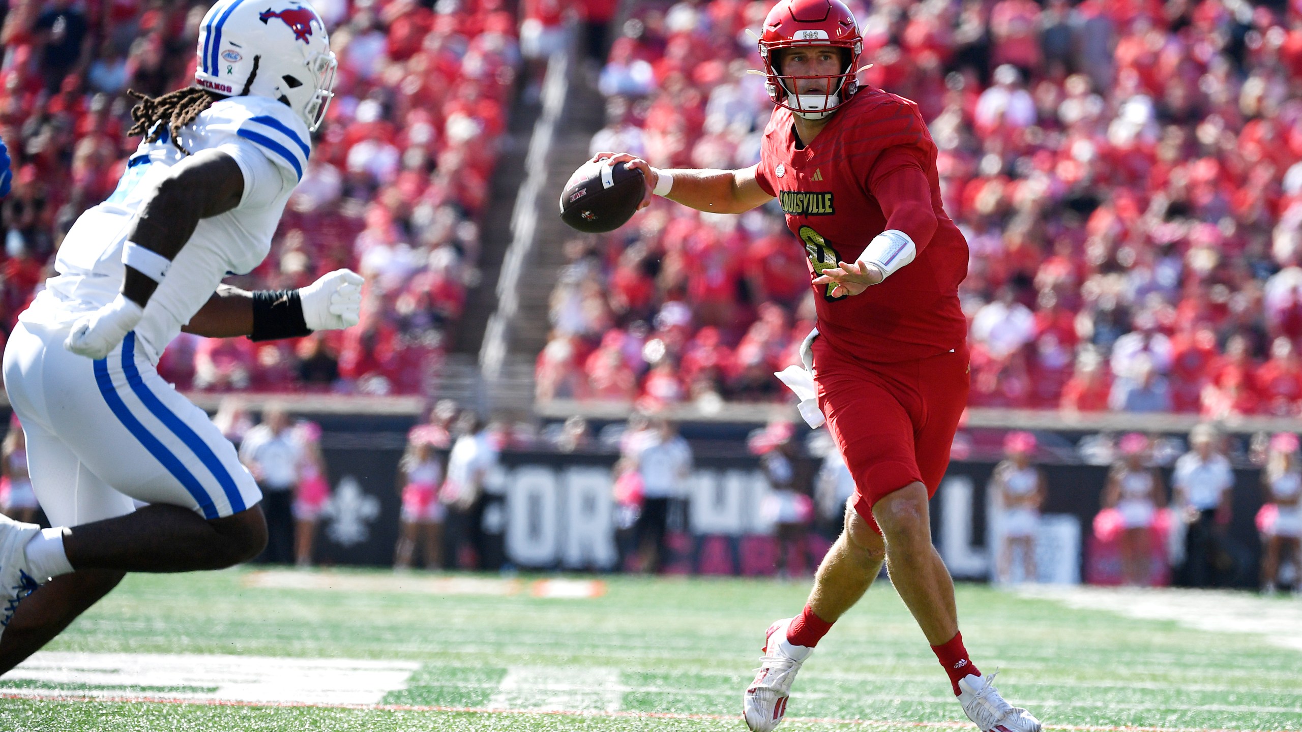 Louisville quarterback Tyler Shough (9) attempts a pass away from the pressure of SMU defensive end Jahfari Harvey (6) during the first half of an NCAA college football game in Louisville, Ky., Saturday, Oct. 5, 2024. (AP Photo/Timothy D. Easley)