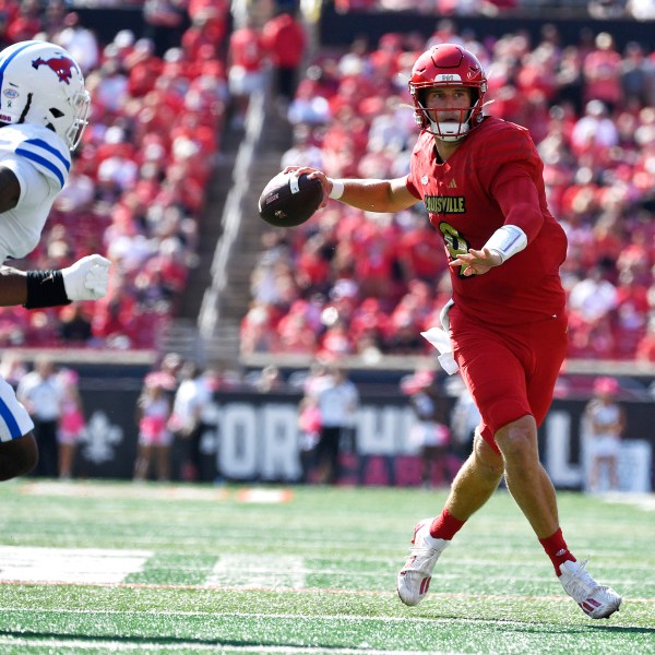 Louisville quarterback Tyler Shough (9) attempts a pass away from the pressure of SMU defensive end Jahfari Harvey (6) during the first half of an NCAA college football game in Louisville, Ky., Saturday, Oct. 5, 2024. (AP Photo/Timothy D. Easley)