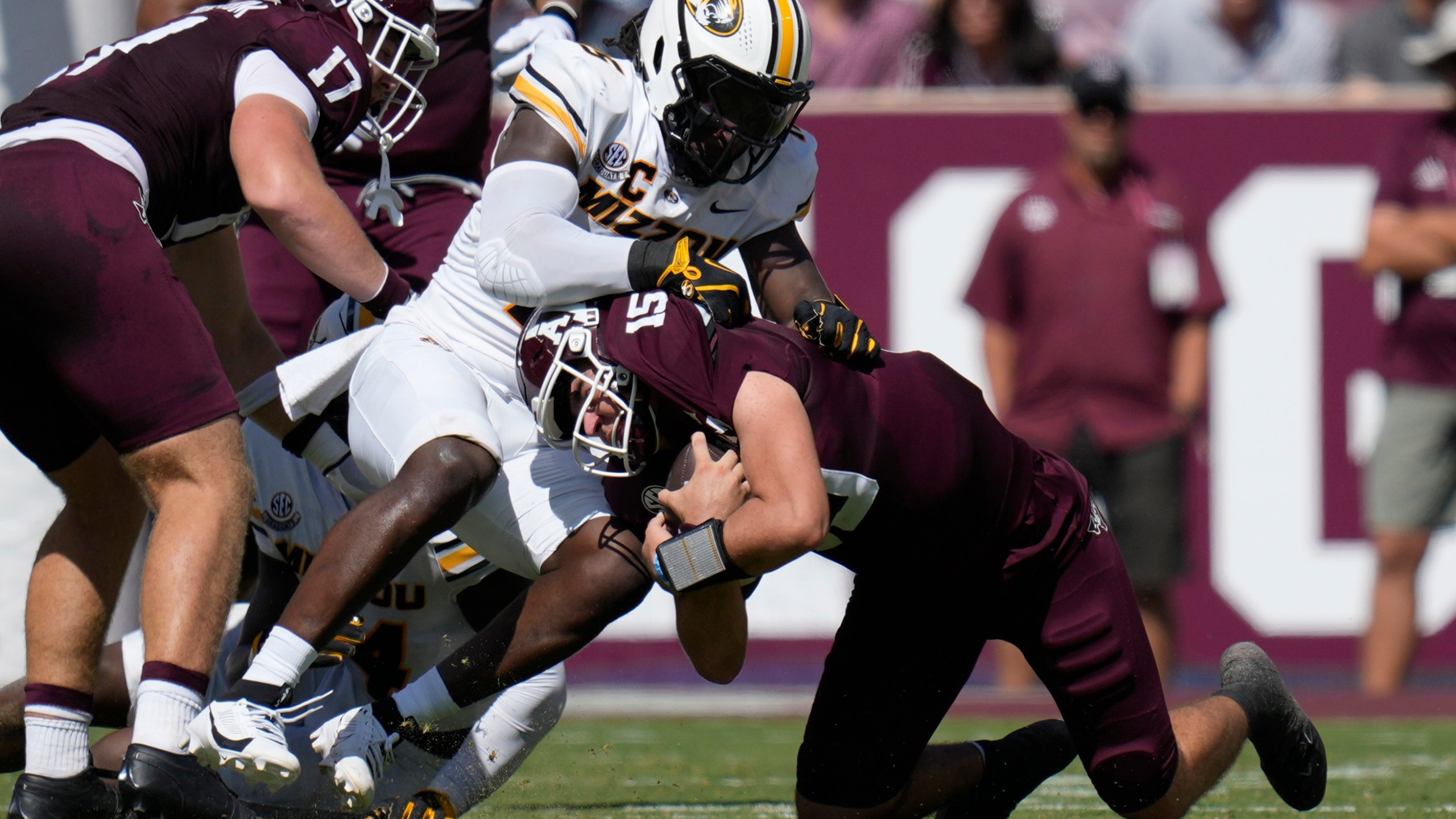 Texas A&M quarterback Conner Weigman, right, is stopped on a run by Missouri defensive end Johnny Walker Jr., left, during the first half of an NCAA college football game Saturday, Oct. 5, 2024, in College Station, Texas. (AP Photo/Eric Gay)