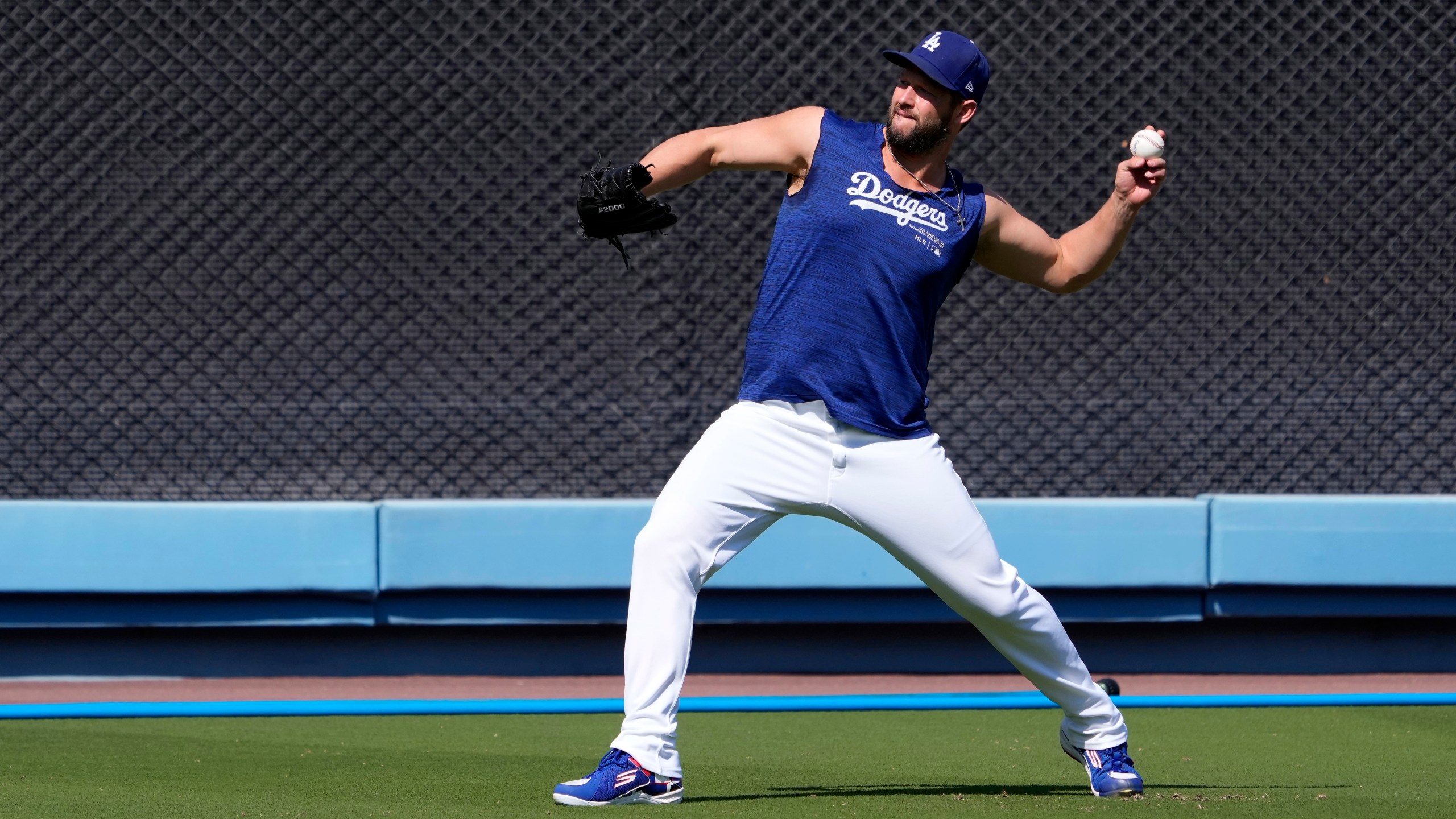 Los Angeles Dodgers pitcher Clayton Kershaw warms up during practice in preparation for Game 1 of a baseball NL Division Series against the San Diego Padres, Thursday, Oct. 3, 2024, in Los Angeles. (AP Photo/Mark J. Terrill)