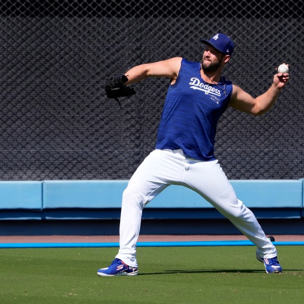 Los Angeles Dodgers pitcher Clayton Kershaw warms up during practice in preparation for Game 1 of a baseball NL Division Series against the San Diego Padres, Thursday, Oct. 3, 2024, in Los Angeles. (AP Photo/Mark J. Terrill)