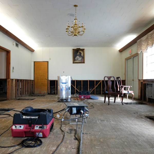 Air movers circulate the air in an effort to dry out the chapel inside Costner-Maloy Funeral Home Saturday, Oct. 5, 2024, which was flooded in the aftermath of Hurricane Helene, in Newport, Tenn. (AP Photo/Jeff Roberson)