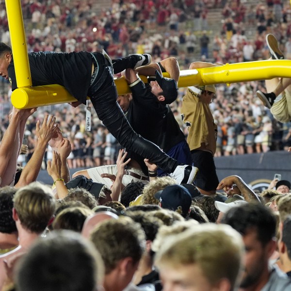 Vanderbilt fans tear down the goal post after the team's 40-35 win against Alabama after an NCAA college football game Saturday, Oct. 5, 2024, in Nashville, Tenn. (AP Photo/George Walker IV)