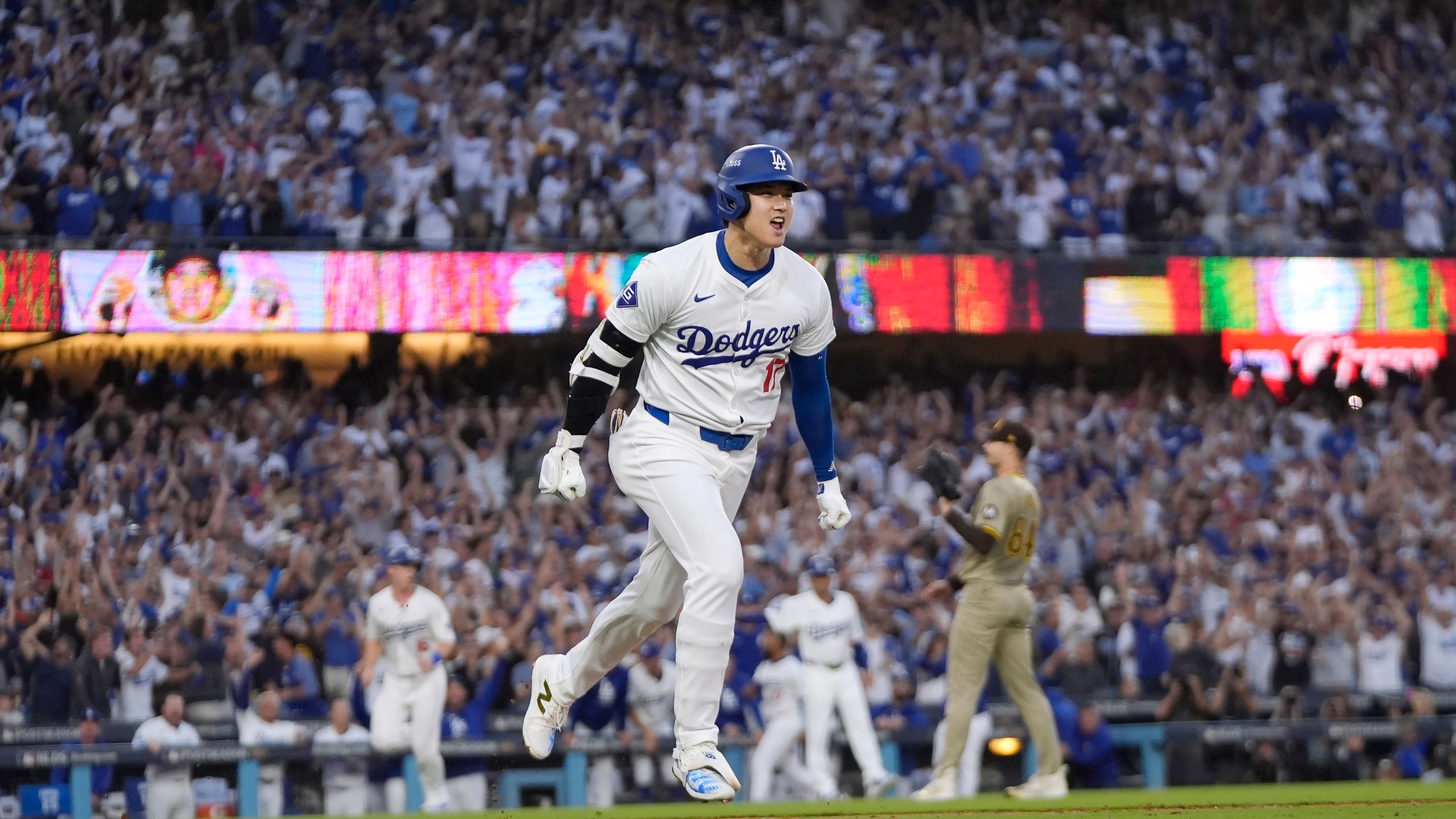 Los Angeles Dodgers' Shohei Ohtani reacts as he rounds first base following his three-run home run during the second inning in Game 1 of baseball's NL Division Series against the San Diego Padres, Saturday, Oct. 5, 2024, in Los Angeles. (AP Photo/Mark J. Terrill)