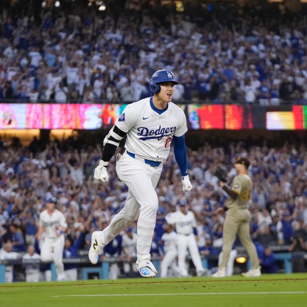 Los Angeles Dodgers' Shohei Ohtani reacts as he rounds first base following his three-run home run during the second inning in Game 1 of baseball's NL Division Series against the San Diego Padres, Saturday, Oct. 5, 2024, in Los Angeles. (AP Photo/Mark J. Terrill)