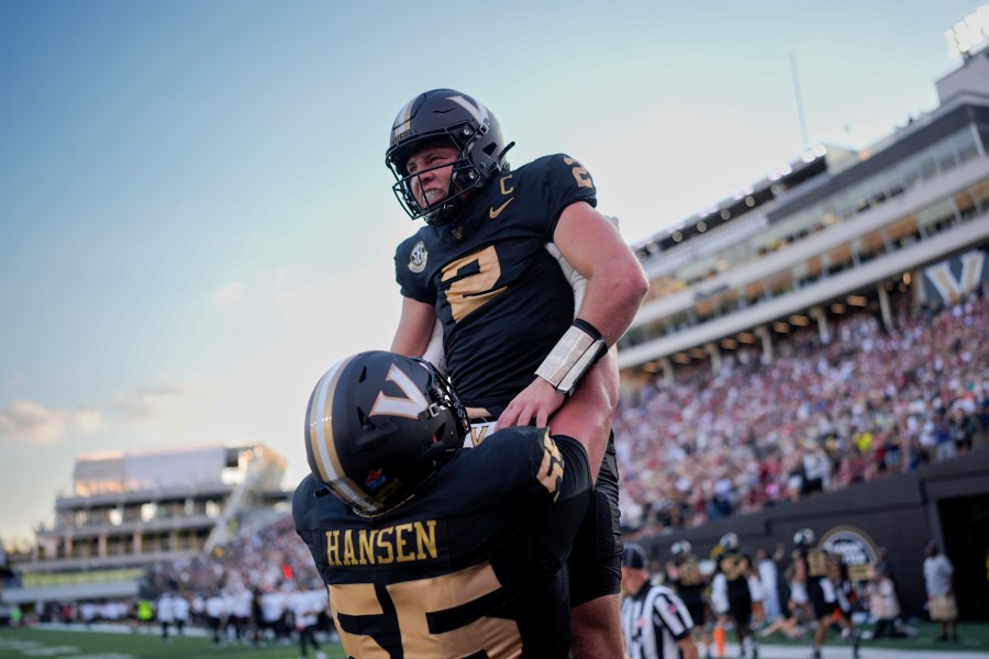 Vanderbilt quarterback Diego Pavia (2) celebrates a touchdown with offensive lineman Gunnar Hansen (55) during the second half of an NCAA college football game against Alabama, Saturday, Oct. 5, 2024, in Nashville, Tenn. (AP Photo/George Walker IV)