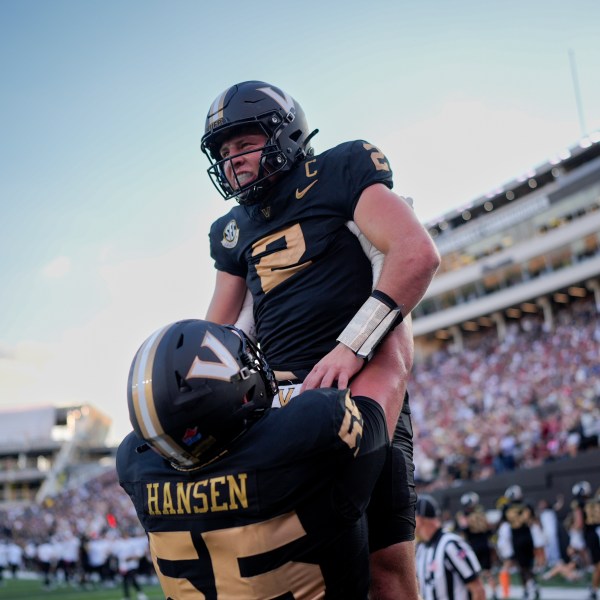 Vanderbilt quarterback Diego Pavia (2) celebrates a touchdown with offensive lineman Gunnar Hansen (55) during the second half of an NCAA college football game against Alabama, Saturday, Oct. 5, 2024, in Nashville, Tenn. (AP Photo/George Walker IV)