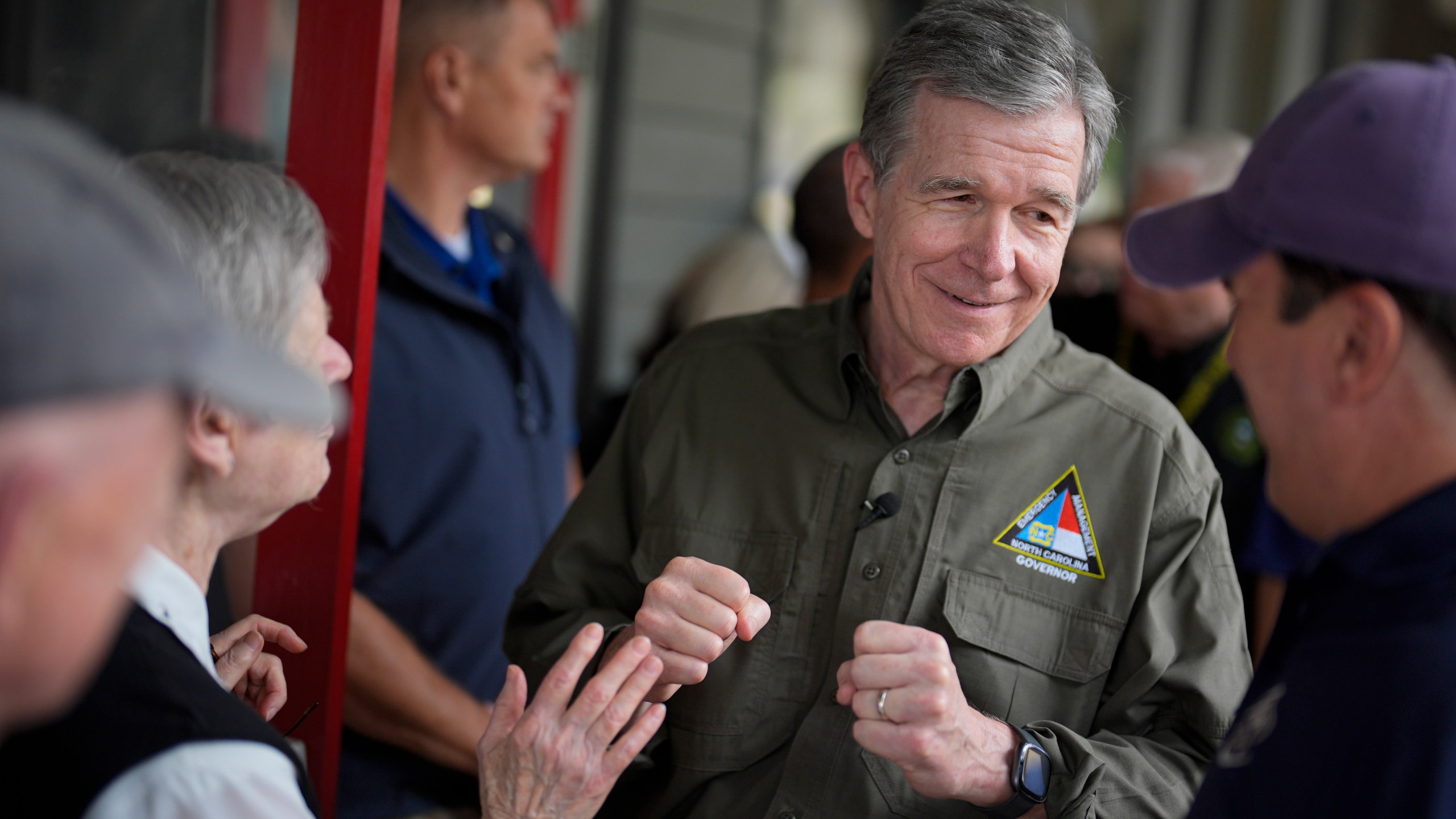 North Carolina governor Roy Cooper greets people on Thursday, Oct. 3, 2024, in Boone, N.C. in the aftermath of hurricane Helene. In the final weeks of the presidential election, people in North Carolina and Georgia, influential swing states, are dealing with more immediate concerns: recovering from Hurricane Helene. (AP Photo/Chris Carlson)