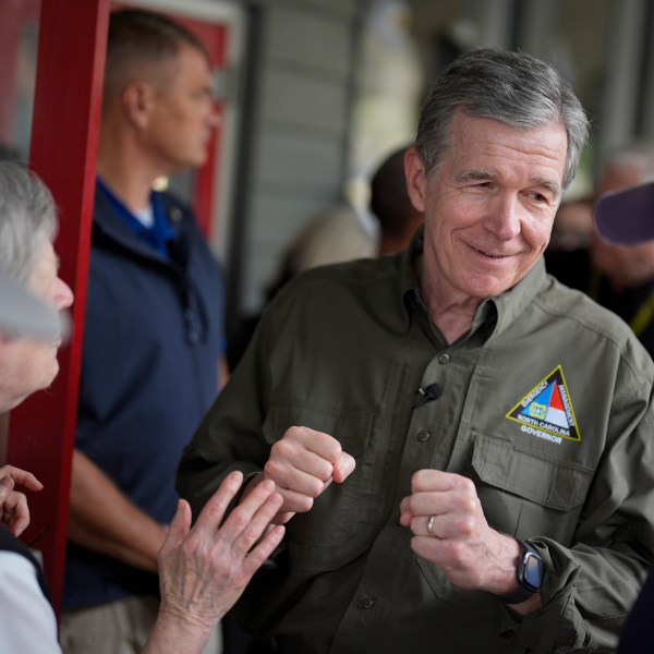 North Carolina governor Roy Cooper greets people on Thursday, Oct. 3, 2024, in Boone, N.C. in the aftermath of hurricane Helene. In the final weeks of the presidential election, people in North Carolina and Georgia, influential swing states, are dealing with more immediate concerns: recovering from Hurricane Helene. (AP Photo/Chris Carlson)