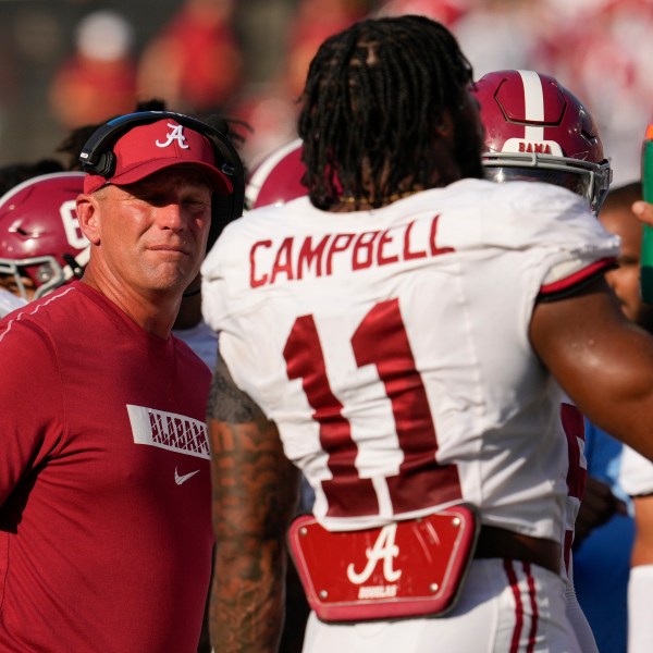 Alabama head coach Kalen DeBoer, left, talks to linebacker Jihaad Campbell (11) during the first half of an NCAA college football game against Vanderbilt, Saturday, Oct. 5, 2024, in Nashville, Tenn. (AP Photo/George Walker IV)