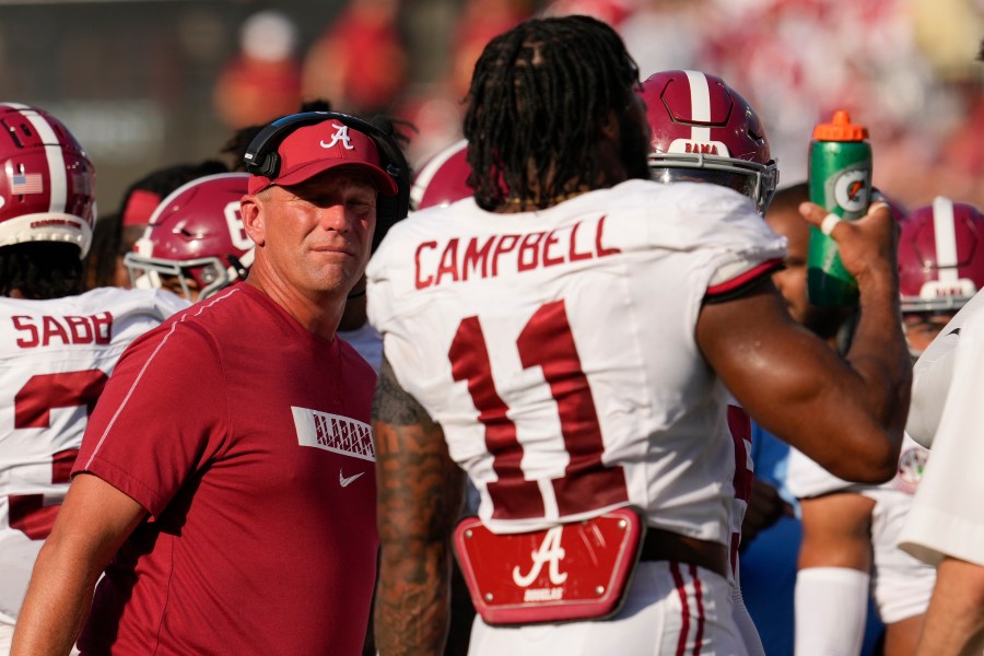 Alabama head coach Kalen DeBoer, left, talks to linebacker Jihaad Campbell (11) during the first half of an NCAA college football game against Vanderbilt, Saturday, Oct. 5, 2024, in Nashville, Tenn. (AP Photo/George Walker IV)