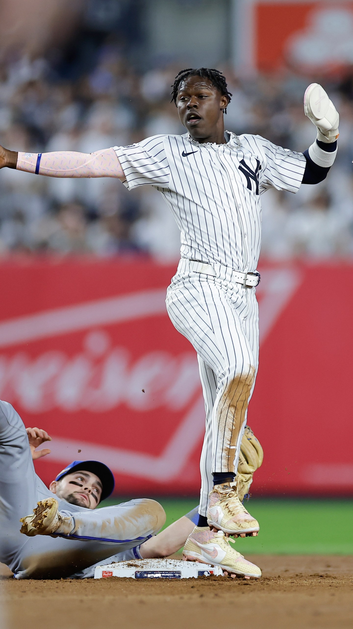 New York Yankees' Jazz Chisholm Jr. (13) reacts as he steals second base safely ahead of the tag from Kansas City Royals second baseman Michael Massey during the seventh inning of Game 1 of the American League baseball division series, Saturday, Oct. 5, 2024, in New York. (AP Photo/Adam Hunger)