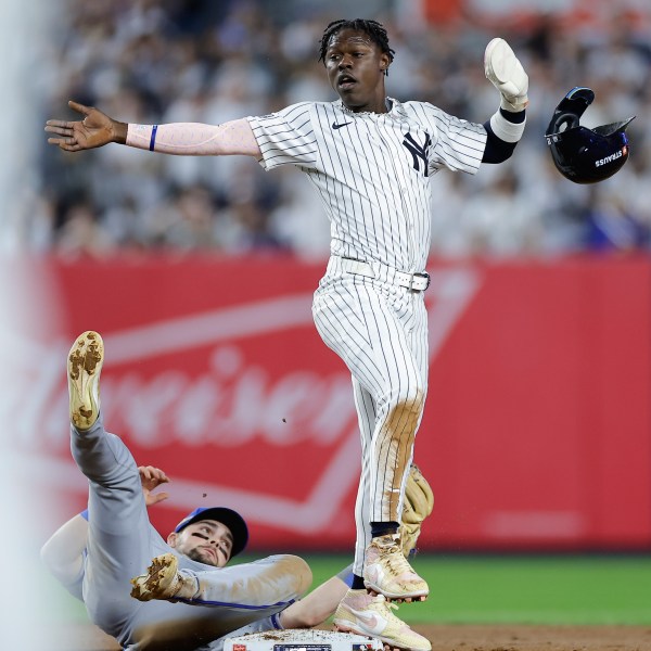 New York Yankees' Jazz Chisholm Jr. (13) reacts as he steals second base safely ahead of the tag from Kansas City Royals second baseman Michael Massey during the seventh inning of Game 1 of the American League baseball division series, Saturday, Oct. 5, 2024, in New York. (AP Photo/Adam Hunger)