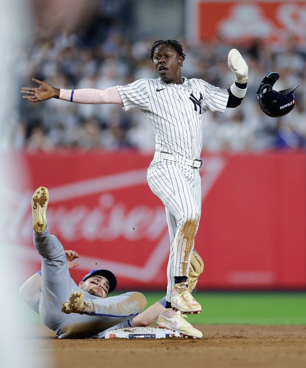 New York Yankees' Jazz Chisholm Jr. (13) reacts as he steals second base safely ahead of the tag from Kansas City Royals second baseman Michael Massey during the seventh inning of Game 1 of the American League baseball division series, Saturday, Oct. 5, 2024, in New York. (AP Photo/Adam Hunger)