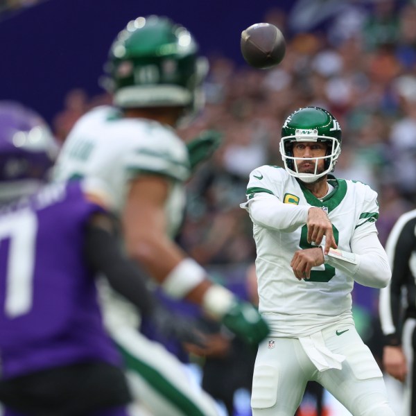 New York Jets quarterback Aaron Rodgers throws during the first half of an NFL football game against the Minnesota Vikings, Sunday, Oct. 6, 2024, at the Tottenham Hotspur stadium in London. (AP Photo/Ian Walton)