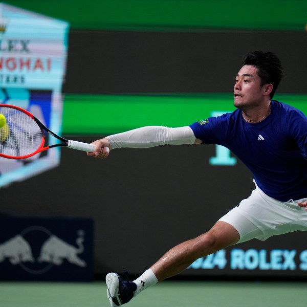 Wu Yibing of China returns a forehand shot to Carlos Alcaraz of Spain during the men's singles third round match of the Shanghai Masters tennis tournament at Qizhong Forest Sports City Tennis Center in Shanghai, China, Sunday, Oct. 6, 2024. (AP Photo/Andy Wong)