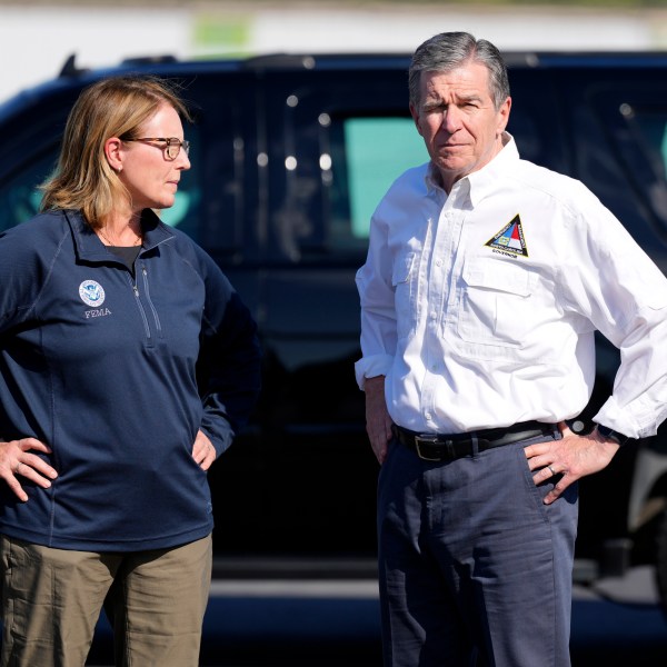 North Carolina Gov. Roy Cooper, right, and Deanne Criswell, Administrator of the U.S. Federal Emergency Management Agency, await the arrival of Democratic presidential nominee Vice President Kamala Harris for a briefing on the damage from Hurricane Helene, at Charlotte Douglas International Airport, Saturday, October 5, 2024, in Charlotte, N.C. (AP Photo/Chris Carlson)