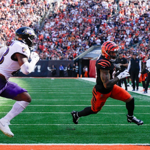 Cincinnati Bengals running back Chase Brown, right, runs in a touchdown after making a catch in front of Baltimore Ravens linebacker Trenton Simpson during the second half of an NFL football game, Sunday, Oct. 6, 2024, in Cincinnati. (AP Photo/Jeff Dean)