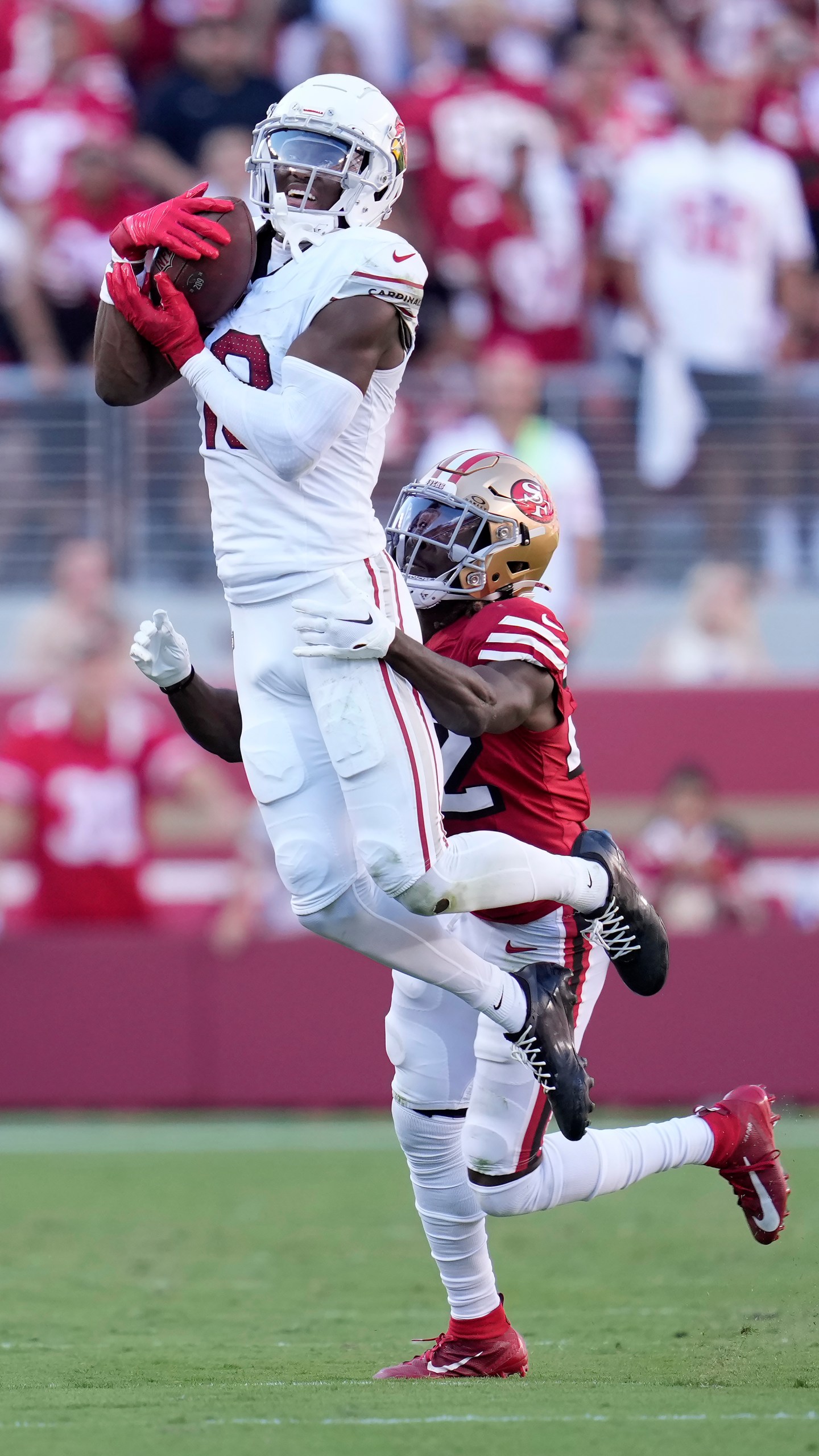 Arizona Cardinals wide receiver Marvin Harrison Jr., top, catches a pass in front of San Francisco 49ers cornerback Isaac Yiadom during the second half of an NFL football game in Santa Clara, Calif., Sunday, Oct. 6, 2024. (AP Photo/Godofredo A. Vásquez)