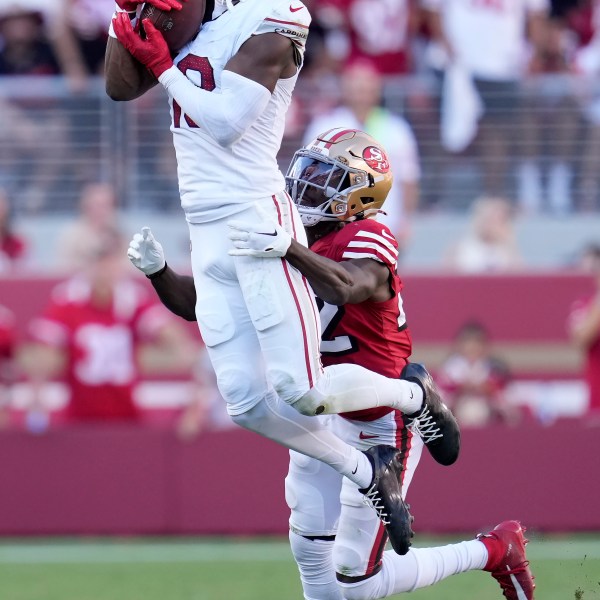 Arizona Cardinals wide receiver Marvin Harrison Jr., top, catches a pass in front of San Francisco 49ers cornerback Isaac Yiadom during the second half of an NFL football game in Santa Clara, Calif., Sunday, Oct. 6, 2024. (AP Photo/Godofredo A. Vásquez)