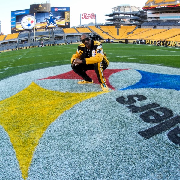 Snoop Dogg poses for photos prior to an NFL football game between the Pittsburgh Steelers and the Dallas Cowboys, Sunday, Oct. 6, 2024, in Pittsburgh. (AP Photo/Gene J. Puskar)