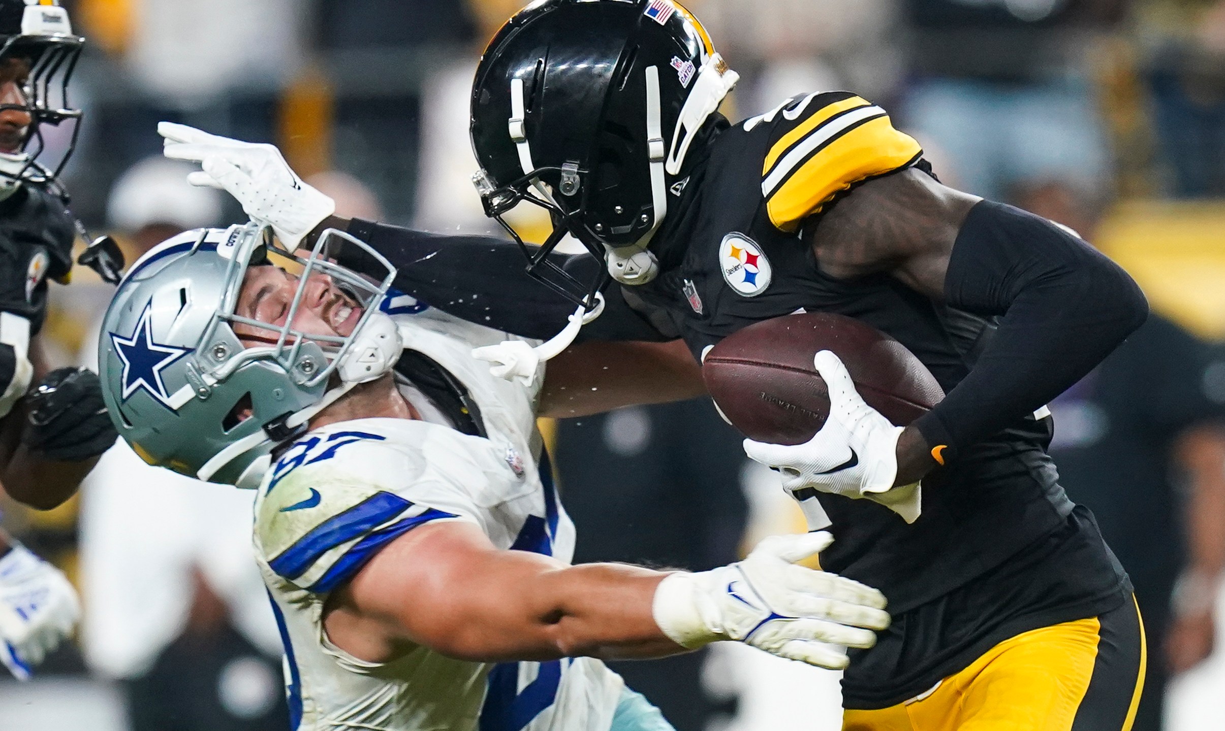 Pittsburgh Steelers cornerback Joey Porter Jr., right, puts a stiff arm on Dallas Cowboys tight end Jake Ferguson after making an interception during the second half of an NFL football game, early Monday, Oct. 7, 2024, in Pittsburgh. The Cowboys won 20-17. (AP Photo/Matt Freed)