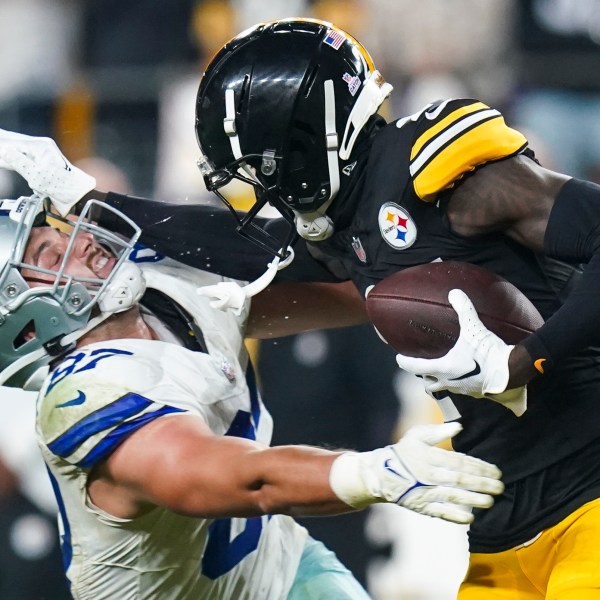 Pittsburgh Steelers cornerback Joey Porter Jr., right, puts a stiff arm on Dallas Cowboys tight end Jake Ferguson after making an interception during the second half of an NFL football game, early Monday, Oct. 7, 2024, in Pittsburgh. The Cowboys won 20-17. (AP Photo/Matt Freed)