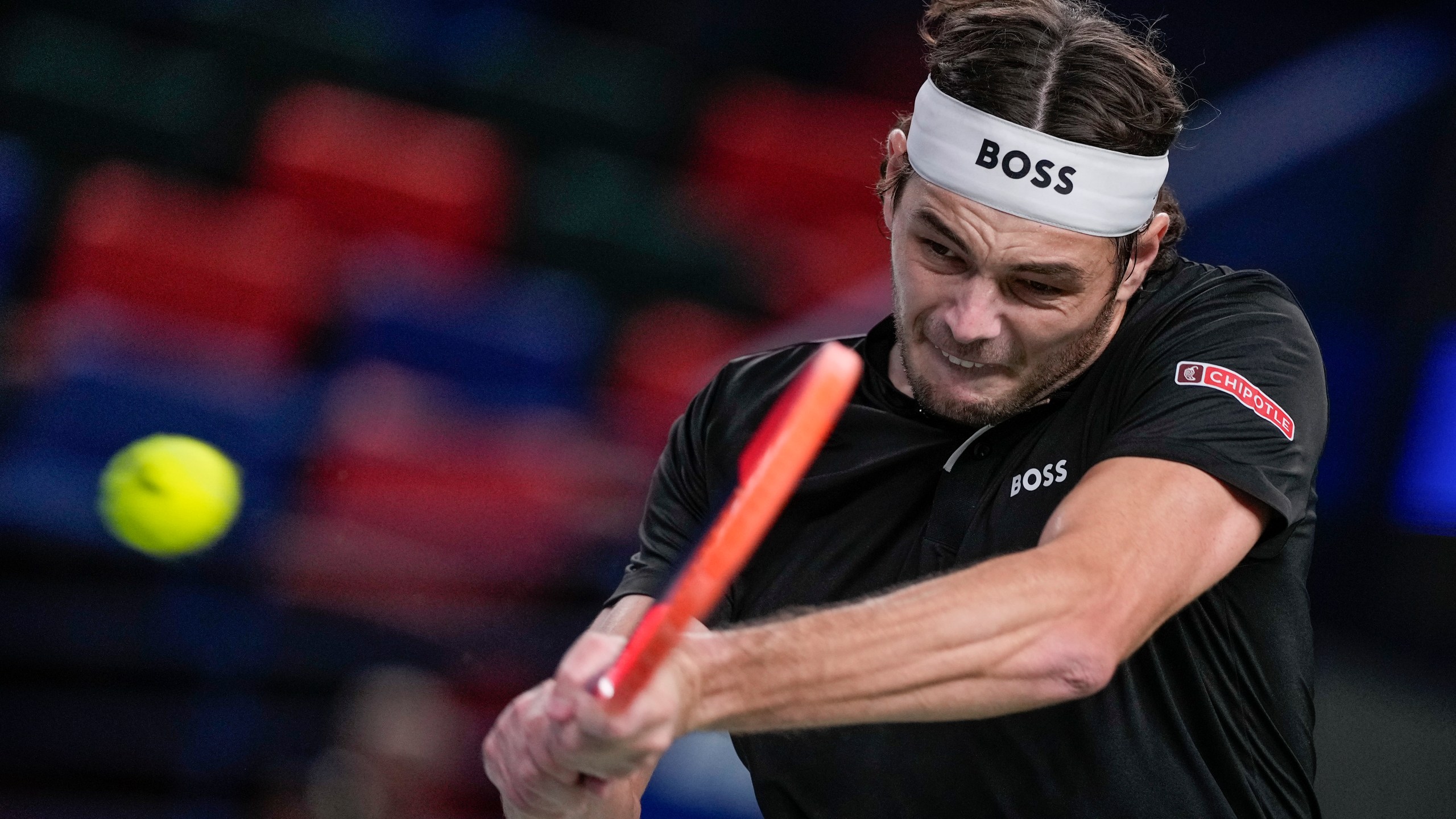 Taylor Fritz of the United States returns a shot to Terence Atmane of France during the men's singles second round match in the Shanghai Masters tennis tournament at Qizhong Forest Sports City Tennis Center in Shanghai, China, Monday, Oct. 7, 2024. (AP Photo/Andy Wong)