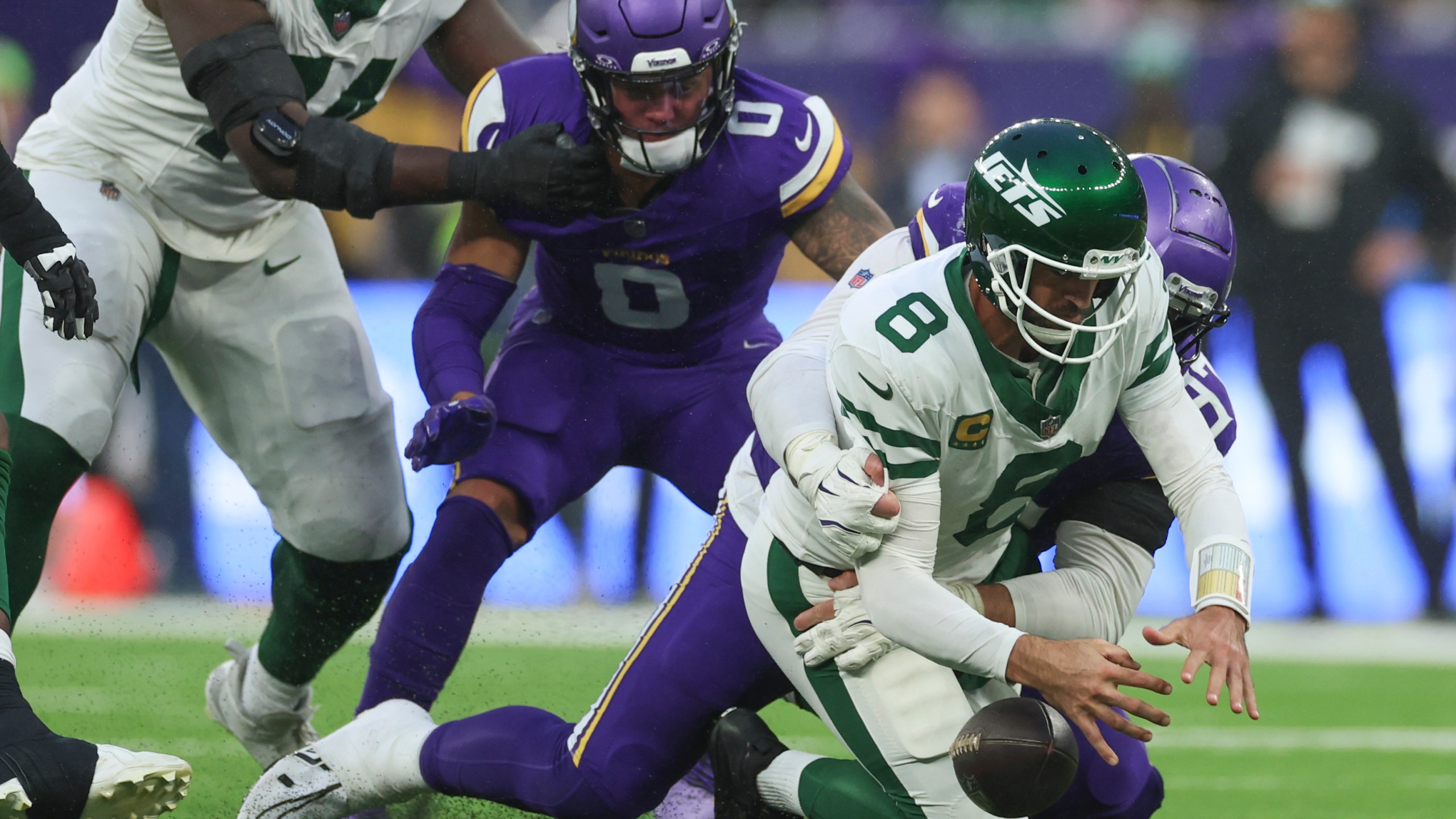 New York Jets quarterback Aaron Rodgers (8), right, is sacked by Minnesota Vikings' Harrison Phillips during the second half of an NFL football game, Sunday, Oct. 6, 2024, at the Tottenham Hotspur stadium in London. (AP Photo/Ian Walton)