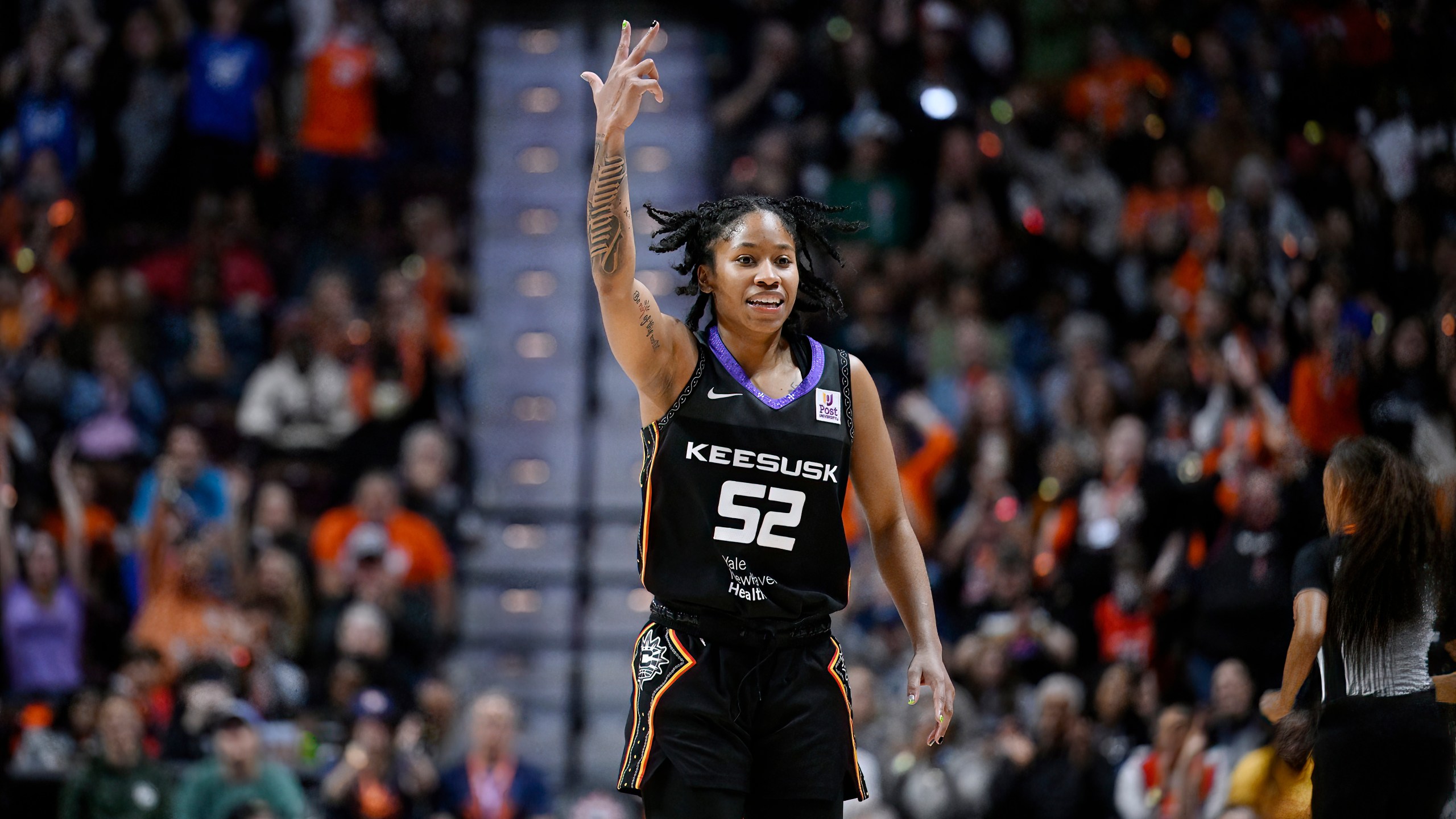 Connecticut Sun guard Tyasha Harris Reacts after making a three point basket during the second half of Game 4 in the WNBA basketball semifinals against the Minnesota Lynx, Sunday, Oct. 6, 2024, in Uncasville, Conn. (AP Photo/Jessica Hill)