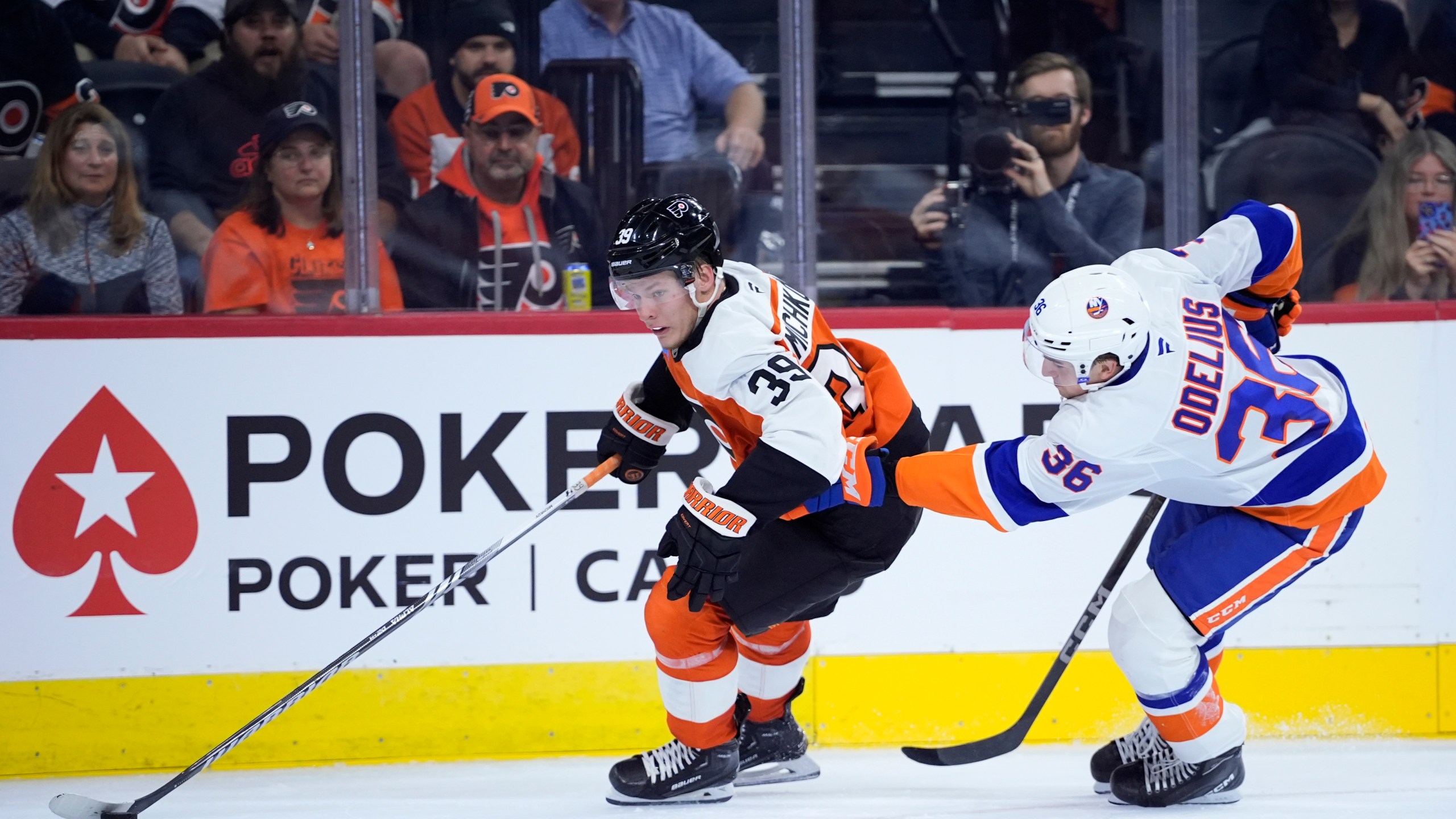 Philadelphia Flyers' Matvei Michkov, left, gets past New York Islanders' Calle Odelius during the second period of a preseason NHL hockey game, Thursday, Sept. 26, 2024, in Philadelphia. (AP Photo/Matt Slocum)