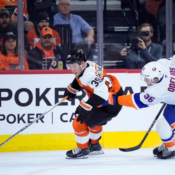 Philadelphia Flyers' Matvei Michkov, left, gets past New York Islanders' Calle Odelius during the second period of a preseason NHL hockey game, Thursday, Sept. 26, 2024, in Philadelphia. (AP Photo/Matt Slocum)