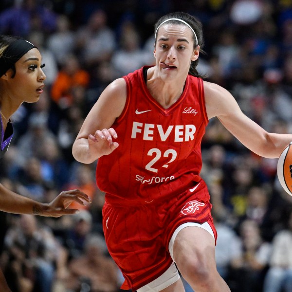 Indiana Fever guard Caitlin Clark (22) drives to the basket as Connecticut Sun guard DiJonai Carrington defends during a first-round WNBA basketball playoff game, Wednesday, Sept. 25, 2024, in Uncasville, Conn. (AP Photo/Jessica Hill)