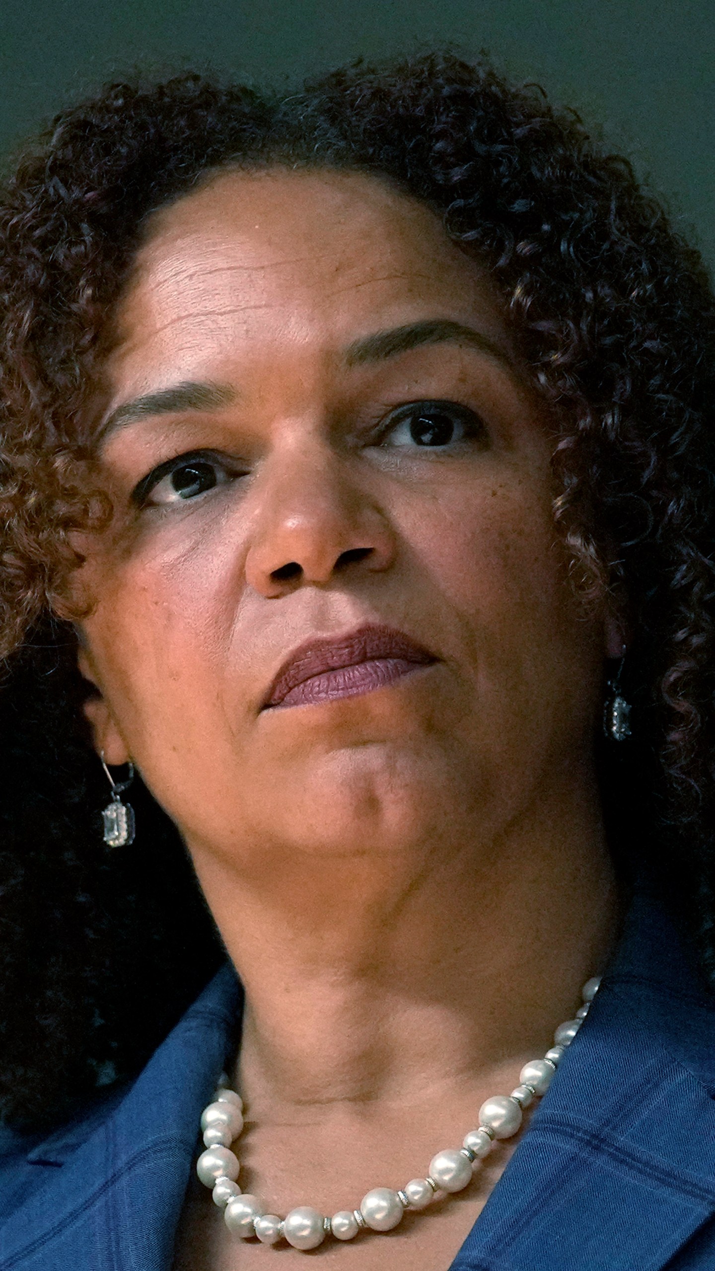 Michilla Blaise, one of six nominees by Chicago Mayor Brandon Johnson to the Chicago Board of Education listens to the mayor during a news conference introducing his nominees Monday, Oct. 7, 2024, in Chicago. (AP Photo/Charles Rex Arbogast)