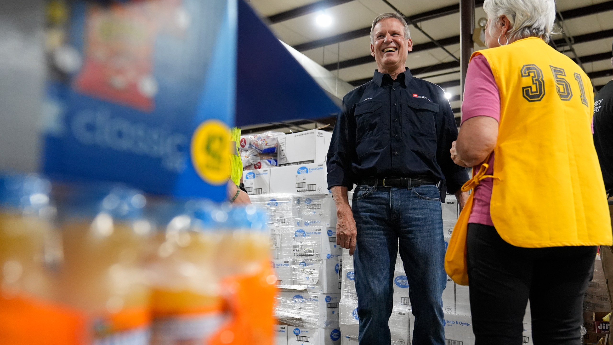 Gov. Bill Lee visits with a volunteer at the East Tennessee Disaster Relief Center, for Hurricane Helene disaster response Monday, Oct. 7, 2024, in Bristol, Tenn. (AP Photo/George Walker IV via Pool)