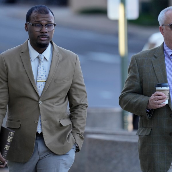 Justin Smith, left, one of three former Memphis police officers charged in the 2023 fatal beating of Tyre Nichols, arrives at the federal courthouse with his attorney Martin Zummach, right, for the day's proceedings Thursday, Oct. 3, 2024, in Memphis, Tenn. (AP Photo/George Walker IV)