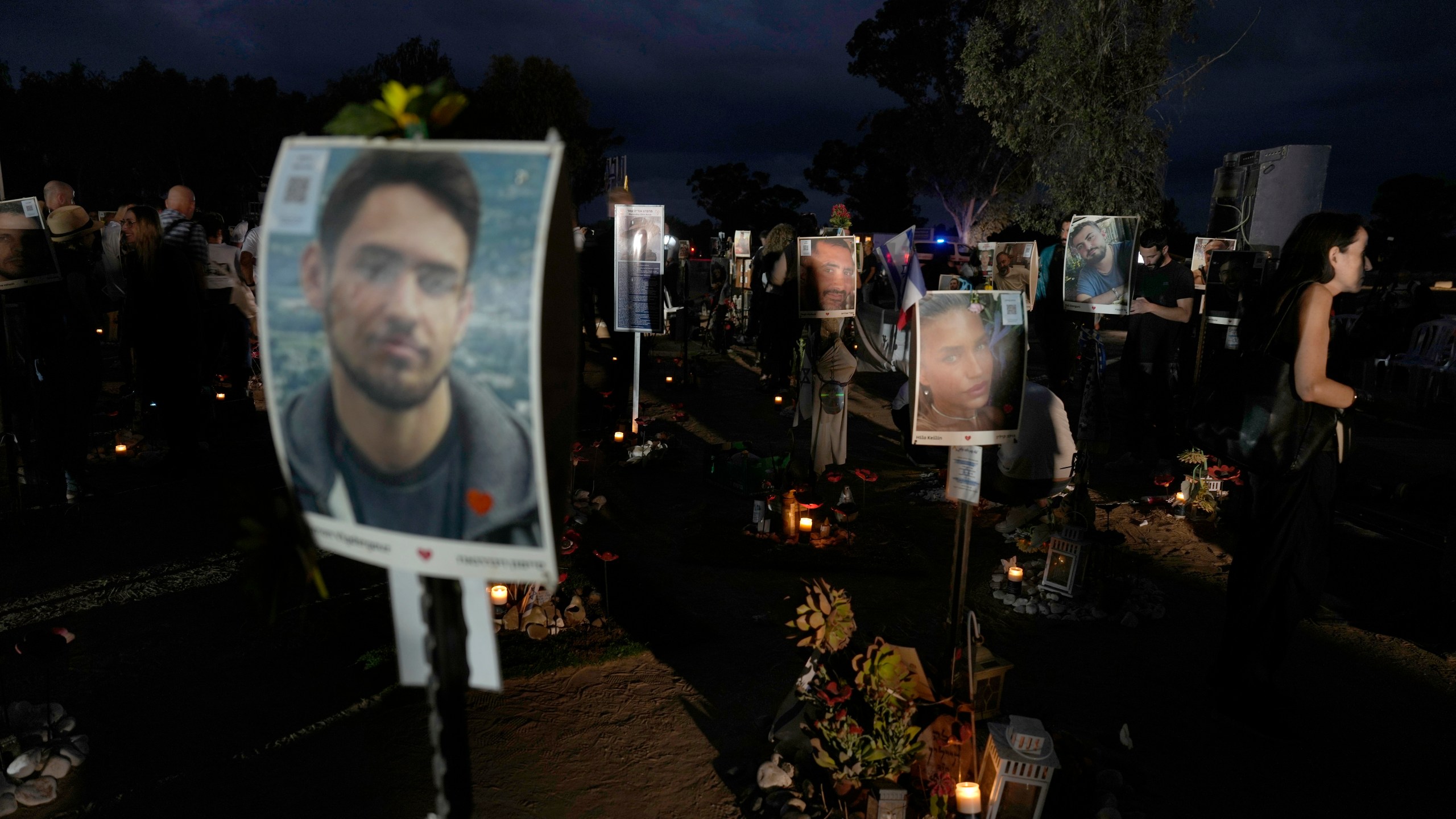 People visit the site of the Nova music festival, where hundreds of revelers were killed and abducted by Hamas and taken into Gaza, on the one-year anniversary of the attack, near Kibbutz Reim, southern Israel, Monday, Oct. 7, 2024. (AP Photo/Ariel Schalit)