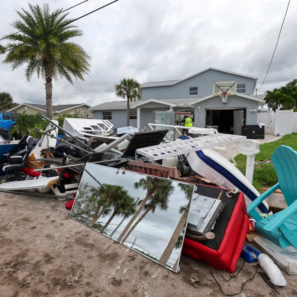 Contractors with the City of New Port Richey help clean debris left by Hurricane Helene in preparation for Hurricane Milton on Monday, Oct. 7, 2024, in New Port Richey, Fla. (AP Photo/Mike Carlson)