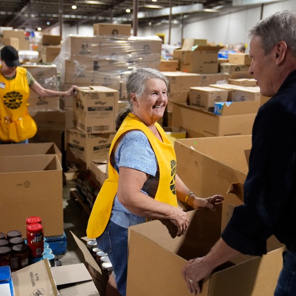 Volunteer Ann Davis speaks with Tennessee Gov. Bill Lee, right, during his visit to the East Tennessee Disaster Relief Center, for Hurricane Helene disaster response Monday, Oct. 7, 2024, in Bristol, Tenn. (AP Photo/George Walker IV via Pool)